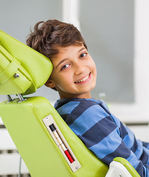 young boy sitting in a dental chair