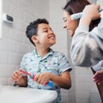 how to help with kids brushing their teeth, family brushing together