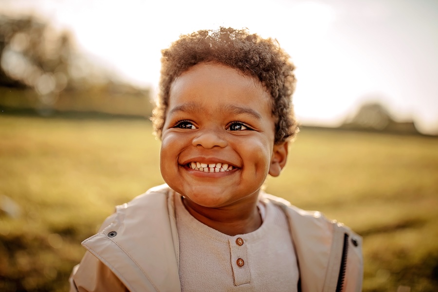 smiling toddler with touching teeth perfect for flossing toddler teeth